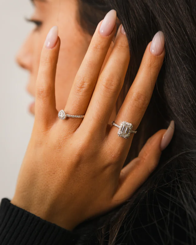 Hand wearing two diamond rings